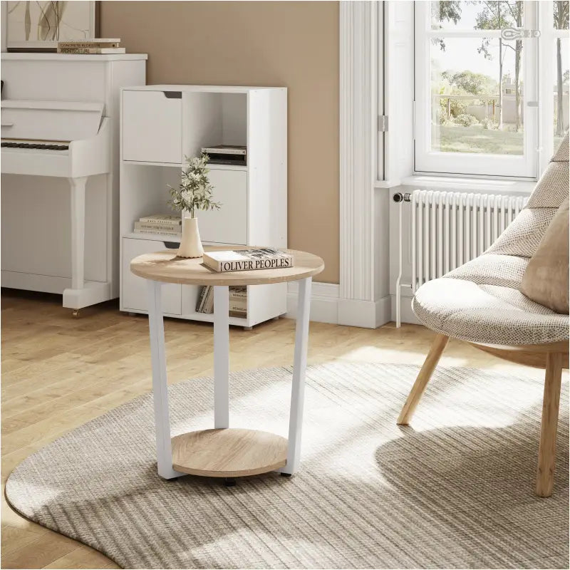 Moderne zwarte metalen bijzettafel van BukkitBow met ronde top en twee planken, perfect voor in de woonkamer.