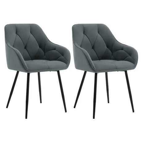 Twee velvet en metalen eetkamerstoelen van BukkitBow met ergonomisch ontwerp en 120 kg draagvermogen, geschikt voor de eetkamer.
